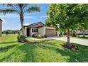 Beautiful single-story home featuring lush lawn, landscaped beds and a convenient two-car garage at 11121 Hudson Hills Ln, Riverview, FL 33579