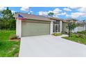Inviting home showcasing a well-maintained lawn and a clean, modern driveway at 11148 Hollander Ave, Hudson, FL 34667