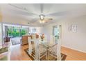Bright dining area with modern glass table and seating open to the living room for seamless entertaining at 12300 Vonn Rd # 7107, Largo, FL 33774