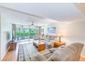 Comfortable living room with plush furniture and sliding glass doors to the lanai at 12300 Vonn Rd # 7107, Largo, FL 33774