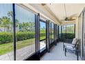 Enclosed patio with black trim windows allowing for natural light and a peaceful view of the well-manicured landscaping at 12300 Vonn Rd # 7107, Largo, FL 33774