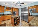 Spacious kitchen features custom wood cabinets, a large island, granite countertops, and stainless steel appliances at 1449 45Th Ne Ave, St Petersburg, FL 33703