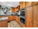 Custom oak kitchen with granite countertops, stainless appliances and center island at 1449 45Th Ne Ave, St Petersburg, FL 33703