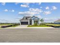 Lovely two-story home with blue accents, manicured lawn and professional landscaping at 1599 Running Tide Pl, Sarasota, FL 34240