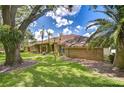 Well-maintained home with mature landscaping, brick exterior, and healthy green lawn at 17917 Clear Lake Dr, Lutz, FL 33548