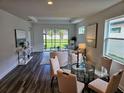 Open-concept living room with wood floors, ample natural light, and stylish furnishings at 2026 Sidney St, Clearwater, FL 33763