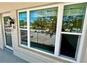 Unit 25 with large windows and balcony view of parking and trees at 2263 Americus E Blvd # 25, Clearwater, FL 33763