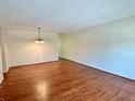 Spacious living room featuring wood floors and a decorative light fixture at 2263 Americus E Blvd # 25, Clearwater, FL 33763