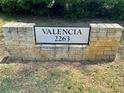 Stone sign indicating address for Valencia with greenery visible behind it at 2263 Americus E Blvd # 25, Clearwater, FL 33763