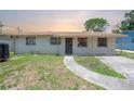 Simple single-story home featuring basic architecture and minimal landscaping at 2614 E Liberty St, Tampa, FL 33612