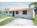 Single-story house with a covered porch and a concrete driveway on a sunny day at 2614 E Liberty St, Tampa, FL 33612