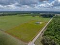 Spacious land parcel showcasing a lovely home nestled among green fields and natural landscapes at 30017 Johnston Rd, Dade City, FL 33523