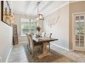 Traditional dining room featuring a wooden table and upholstered chairs and natural light from a window at 3530 Brook Crossing Dr, Brandon, FL 33511