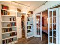 Charming bedroom view through french doors with a view of the closet and book shelving at 3850 13 N Ave # 113, St Petersburg, FL 33713