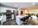 Charming kitchen with stainless steel appliances, white cabinetry, a center island, and open-concept living at 3850 13 N Ave # 113, St Petersburg, FL 33713