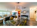 Bright living room featuring a glass dining table, stylish chandelier, and an open layout with plenty of natural light at 3850 13 N Ave # 113, St Petersburg, FL 33713
