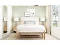 Bright bedroom featuring a large bed with stylish bedding, nightstands with lamps, and a window at 4022 Northern Key Dr, Plant City, FL 33563