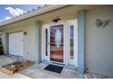 Elegant front door with glass detail enhances curb appeal at 5480 Orange Blossom N Rd, Pinellas Park, FL 33782
