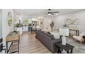 Open concept living room and kitchen area with hardwood floors and modern decor at 5624 62Nd N St, St Petersburg, FL 33709