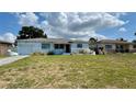 Quaint home with light blue paint and landscaping features in a residential neighborhood at 5711 9Th N Ave, St Petersburg, FL 33710