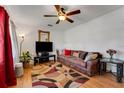 Cozy living room with hardwood floors, ceiling fan, and comfortable seating with a flat screen television at 5711 9Th N Ave, St Petersburg, FL 33710