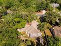 Bird's eye view of a home's roof surrounded by dense trees, showcasing the privacy and seclusion of the location at 577 Waterfall Dr, Spring Hill, FL 34608