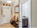 Inviting foyer featuring tile flooring and convenient access to a half bathroom at 601 52Nd Ter N, St Petersburg, FL 33703