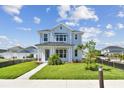 Charming two-story home with a well-manicured lawn and inviting walkway at 7304 Donnybrook Ln, Sarasota, FL 34240