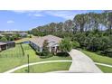 Lovely aerial view of a well-maintained home with mature trees and a fenced yard by the water at 8016 Rock Spring Ct, Land O Lakes, FL 34638