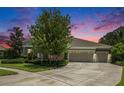 Beautiful single-Gathering home featuring lush landscaping, a spacious driveway, and a three-car garage at 8016 Rock Spring Ct, Land O Lakes, FL 34638