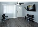 Open living room featuring stylish gray flooring, ceiling fan, and neutral wall color at 8996 Southern Comfort Dr, Largo, FL 33773