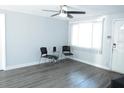 Bright living room with neutral wall color, gray flooring, and large window at 8996 Southern Comfort Dr, Largo, FL 33773