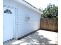 Exterior side view of property featuring white door and privacy fence at 8996 Southern Comfort Dr, Largo, FL 33773