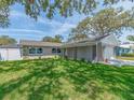 Inviting single-story home with a well-maintained lawn, showcasing a peaceful residential setting at 9292 120Th Ln, Seminole, FL 33772