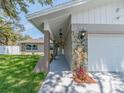 Inviting single-story home with decorative stone features, overhead lights, and a well-kept lawn at 9292 120Th Ln, Seminole, FL 33772