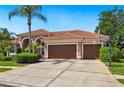 Lovely single-story home with clay tile roofing and a spacious driveway with basketball hoop at 9912 Chris Craft Ct, Tampa, FL 33615