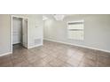 Bright dining room with chandelier, tile floors and a large window at 10326 Boggy Moss Dr, Riverview, FL 33578