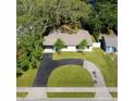 An aerial view of a well-manicured property showcasing a circular driveway and lush landscaping at 10406 N Boulevard, Tampa, FL 33612