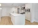 A modern kitchen featuring a white island, stainless steel appliances, and light wood floors at 1120 E Kennedy Blvd # 1127, Tampa, FL 33602