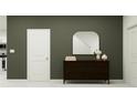 Stylish hallway features a dark wood dresser with an arched mirror, with white trim and doors at 11746 Brae Way, Dade City, FL 33525