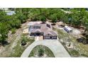 Sprawling single-story home featuring a screened-in pool and a three-car garage on a large lot at 13110 Manistee Rd, Weeki Wachee, FL 34614