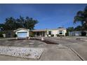 Charming home boasts a well-manicured lawn, colorful flower beds, and a two-car garage at 1444 Eastfield Dr, Clearwater, FL 33764