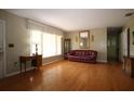 Bright living room with hardwood floors, large windows, and ample space for entertaining at 1444 Eastfield Dr, Clearwater, FL 33764