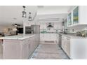 Bright kitchen with stainless steel appliances and a large island at 1907 Sandpiper Dr, Clearwater, FL 33764