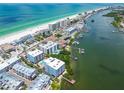 A stunning aerial view of condos, a marina, and a pristine beach at 19925 Gulf Blvd # 105, Indian Shores, FL 33785