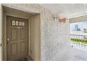Condo entryway featuring a textured wall and unit number 105 at 19925 Gulf Blvd # 105, Indian Shores, FL 33785