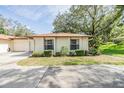 Close-up view of one-story home with a well-manicured lawn and a two-car garage at 2150 Shelly Dr # D, Palm Harbor, FL 34684