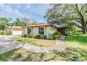 Well-kept one-story home with manicured lawn, mature trees and inviting curb appeal at 2150 Shelly Dr # D, Palm Harbor, FL 34684