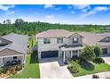 An elevated view of this lovely home featuring manicured landscaping and a long driveway in a suburban neighborhood at 21874 Crest Meadow Dr, Land O Lakes, FL 34637