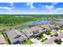 Aerial view of a residential area that features a lake, private swimming pools, and mature trees at 21874 Crest Meadow Dr, Land O Lakes, FL 34637